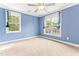 Comfortable bedroom with carpet floors and two windows with bright natural light at 305 Georgetown Rd, Raleigh, NC 27608