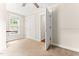 Bright bedroom featuring a window, ceiling fan, and closet for a comfortable and functional space at 305 Georgetown Rd, Raleigh, NC 27608