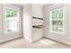 Inviting bedroom featuring two windows and a unique wall-mounted desk, perfect for a productive space at 305 Georgetown Rd, Raleigh, NC 27608