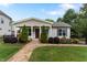 Charming single-story home featuring a stone walkway, manicured lawn, and delightful landscaping at 305 Georgetown Rd, Raleigh, NC 27608