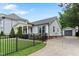 Delightful home with manicured lawn, wrought iron fence, and a detached garage with a private driveway at 305 Georgetown Rd, Raleigh, NC 27608