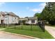 Inviting home with an immaculate lawn, a stone walkway, and a black fence enhancing curb appeal at 305 Georgetown Rd, Raleigh, NC 27608