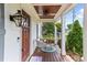 Charming front porch adorned with stylish seating and decor, complemented by the front door and landscaping at 305 Georgetown Rd, Raleigh, NC 27608