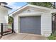 Exterior view of the detached garage featuring a gray door and a well-maintained exterior at 305 Georgetown Rd, Raleigh, NC 27608