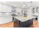 Spacious kitchen with a large island, granite countertops, and stainless steel appliances at 305 Georgetown Rd, Raleigh, NC 27608