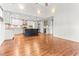 Bright, open-concept kitchen with hardwood floors, white cabinets and a dark island at 305 Georgetown Rd, Raleigh, NC 27608