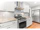 Modern kitchen featuring stainless steel appliances and granite countertops at 305 Georgetown Rd, Raleigh, NC 27608