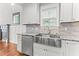Close up of the kitchen details with the island, sink and stainless steel appliances at 305 Georgetown Rd, Raleigh, NC 27608