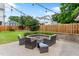 Backyard patio with built-in stone fire pit and outdoor seating under string lights at 305 Georgetown Rd, Raleigh, NC 27608