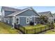 Well-maintained backyard with screened porch, barbecue, and black metal fencing at 33 Davidson St, Clayton, NC 27527