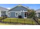 A fenced backyard with a screened porch and a grill on the patio surrounded by well-maintained grass at 33 Davidson St, Clayton, NC 27527