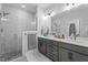 Bathroom features double sink vanity, marble tile shower with glass surround, and a large mirror at 33 Davidson St, Clayton, NC 27527