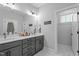 Bathroom features double sink vanity, white marble floors, and a large mirror at 33 Davidson St, Clayton, NC 27527