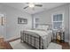 Neutral bedroom featuring a metal bed frame, ceiling fan, and lots of natural light from the windows at 33 Davidson St, Clayton, NC 27527