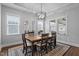 Dining room with a wood table, seating for six, a modern chandelier, and lots of natural light from the large windows at 33 Davidson St, Clayton, NC 27527