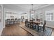 Dining room with a wood table, seating for six, a modern chandelier, and an open layout to the kitchen at 33 Davidson St, Clayton, NC 27527