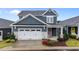 Charming two-story home with a two-car garage, inviting porch, and well-maintained landscaping at 33 Davidson St, Clayton, NC 27527
