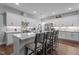 Bright and open kitchen featuring a large island with bar stool seating and stylish pendant lighting at 33 Davidson St, Clayton, NC 27527