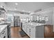 Spacious kitchen showcasing a central island, modern appliances, and an open layout to the dining area at 33 Davidson St, Clayton, NC 27527