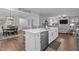 Modern kitchen with a large center island, stainless steel appliances, and an open layout to the dining and living areas at 33 Davidson St, Clayton, NC 27527
