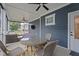 This enclosed porch features a dining table, seating, and a ceiling fan at 33 Davidson St, Clayton, NC 27527