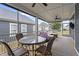 This enclosed porch features a dining table, seating, and a ceiling fan at 33 Davidson St, Clayton, NC 27527