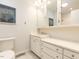 Neat bathroom featuring white cabinetry, drawers, and a framed mirror at 3421 Angus Rd, Durham, NC 27705