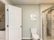 Well-lit bathroom with sleek fixtures, tile flooring, and modern shower at 3421 Angus Rd, Durham, NC 27705