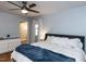 Spacious bedroom featuring hardwood floors, ample natural light, and a ceiling fan at 3421 Angus Rd, Durham, NC 27705