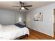 Comfortable bedroom features hardwood flooring, ceiling fan, and bright natural light at 3421 Angus Rd, Durham, NC 27705