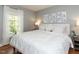 Comfortable bedroom featuring a large bed, bright window, and tasteful decor at 3421 Angus Rd, Durham, NC 27705
