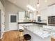 Bright kitchen features a granite island, stainless steel appliances, and modern lighting at 3421 Angus Rd, Durham, NC 27705