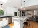Modern kitchen with granite island, stainless appliances, and open floor plan to living room at 3421 Angus Rd, Durham, NC 27705