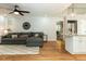 Inviting living room featuring a large sectional sofa, hardwood floors, and an open kitchen layout at 3421 Angus Rd, Durham, NC 27705