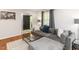Comfortable living room with hardwood floors, large sectional sofa, and bright natural light at 3421 Angus Rd, Durham, NC 27705