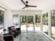 Sun-drenched sun room with sliding glass doors leading to an outdoor deck and lush greenery at 3421 Angus Rd, Durham, NC 27705