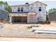 Unfinished two-story home with an attached two-car garage, surrounded by construction materials in a new community at 3861 Rosebush Dr, Zebulon, NC 27597