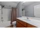 A bathroom with a tub, shower, and vanity with wood cabinets at 39 Mcguire Ln, Clayton, NC 27527