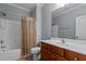 Bathroom featuring a shower with curtain and vanity with wooden cabinet at 39 Mcguire Ln, Clayton, NC 27527