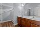 A bathroom with double sinks, wood cabinets, and framed mirror at 39 Mcguire Ln, Clayton, NC 27527
