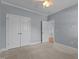 Bedroom featuring a ceiling fan, neutral carpeting, and a closet with double doors at 39 Mcguire Ln, Clayton, NC 27527