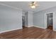 A cozy bedroom with a ceiling fan, hardwood floors, and access to bathroom at 39 Mcguire Ln, Clayton, NC 27527