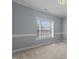Serene bedroom featuring a large window, neutral walls, and soft carpeting at 39 Mcguire Ln, Clayton, NC 27527