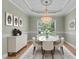 Dining room with a decorative chandelier, neutral furniture, and natural light through a window at 39 Mcguire Ln, Clayton, NC 27527