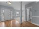 Bright foyer with hardwood floors, white trim, and view of the bathroom at 39 Mcguire Ln, Clayton, NC 27527