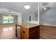Open kitchen with granite countertops, wooden cabinets, and a kitchen island with a wooden base at 39 Mcguire Ln, Clayton, NC 27527