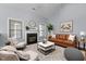 Elegant living room with fireplace, large windows, and stylish furnishings at 39 Mcguire Ln, Clayton, NC 27527