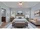 Bright main bedroom with a ceiling fan, sitting area, and two windows at 39 Mcguire Ln, Clayton, NC 27527