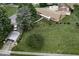 Bird's-eye view of a home with expansive lawn, mature trees, and a detached garage at 403 E Mcpherson Dr, Mebane, NC 27302