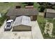 A detailed aerial perspective showcasing a garage, truck and additional storage buildings on the property at 403 E Mcpherson Dr, Mebane, NC 27302